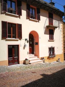 a white building with red doors and windows at Bella Vigezzo in Craveggia