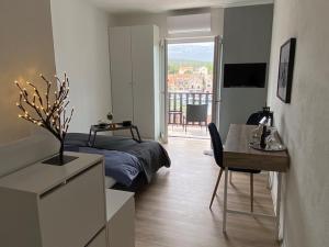 a bedroom with a bed and a table and a tableablish at Mediteran Hvar - Modern Rooms and Restaurant, B&B in Vrboska