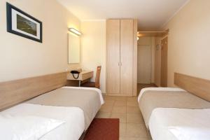 Ein Bett oder Betten in einem Zimmer der Unterkunft Hotel Delfin Plava Laguna