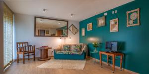 a living room with a couch and a television at Casa dos Castanheiros in Vila Verde