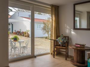 an open door to a patio with a table and chairs at Casa dos Castanheiros in Vila Verde
