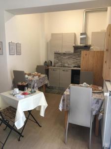 a kitchen with two tables and two chairs in a room at Il lago del Mugello B&B in Barberino di Mugello