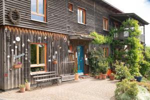 a wooden house with a bench in front of it at Sweet Home in Gedern