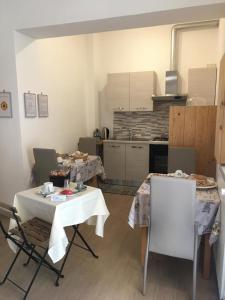 una cocina con 2 mesas y sillas en una habitación en Il lago del Mugello B&B, en Barberino di Mugello