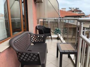 a balcony with two chairs and a table at Hotel Silver in Sozopol