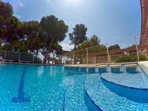 a large swimming pool with blue water at Trill Mirasol E estudio 1a linea mar in L'Estartit