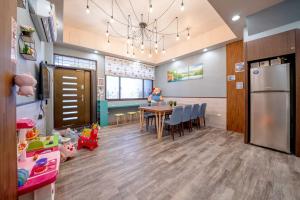 a kitchen and dining room with a table and a refrigerator at Han Tian Tong Cai B&B in Wujie