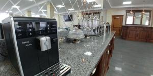 a kitchen with a counter with a coffee maker at Hotel Meridian in Brody