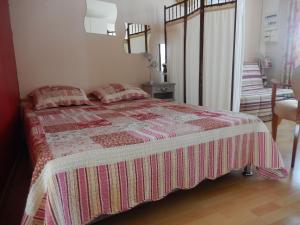 a bedroom with a bed with two pillows on it at Calme et verdure en plein coeur d Illiers Combray in Illiers