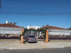 a car parked in a parking lot in front of a garage at HOTEL CASABLANCA in Aparecida de Goiânia