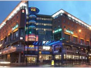 a large building on a city street at night at Smart Town Centre Apartments in Northampton