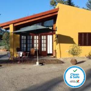 a yellow house with a sign in front of it at Casas de Canavezes in Marco de Canavezes