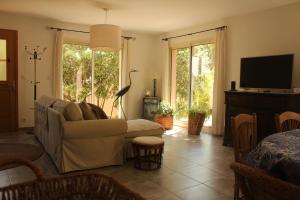 a living room with a couch and a television at La Rousse in Roussillon