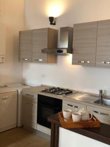 a kitchen with a stove and some bowls on a table at Klimt's Mill overlooking Port in Malcesine