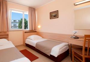 Ein Bett oder Betten in einem Zimmer der Unterkunft Hotel Delfin Plava Laguna