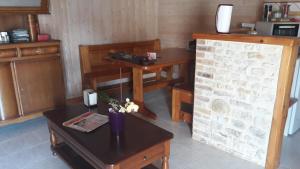 a living room with a table and a telephone at La maison neuve in Fontaines