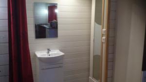 a bathroom with a sink and a mirror at chalet 2 personnes in Mialanes