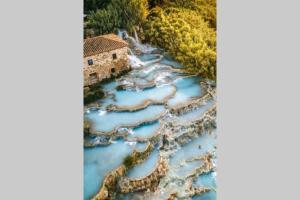 an aerial view of a river with a house at La Casa all'Oliveto in Pitigliano