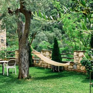 a hammock hanging from a tree in a garden at Chateau Fasel in Tirana