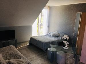 a bedroom with a bed and a glass table at U Wróbelka in Grzybowo +6 photos
