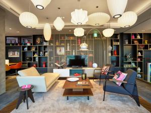 
a living room filled with furniture and a fire place at citizenM Taipei North Gate in Taipei
