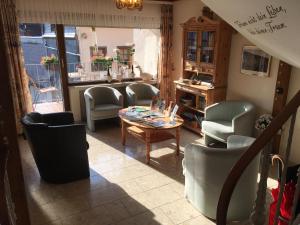 a living room with chairs and a table and a dining room at Ferienpension bei Stenze in Senheim