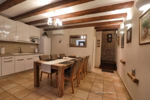 a kitchen and dining room with a table and chairs at Old town house in Pag