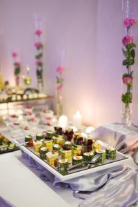 a table with a tray of food on a table at Alabaster Rezydencja in Rzeszów