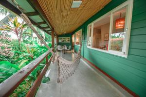 a porch with a hammock on a house at Pousada Verdes Mares in Fernando de Noronha +46 photos