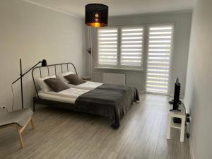 Posteľ alebo postele v izbe v ubytovaní APARTAMENT KILIŃSKIEGO 9