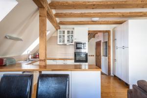 a kitchen with white cabinets and a wooden counter top at Penzion Nostalgia in Banská Štiavnica