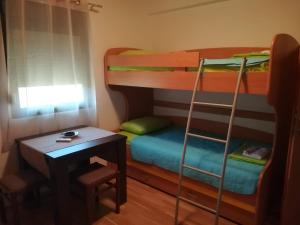 a room with two bunk beds and a desk at Forest Apartments in Kotor