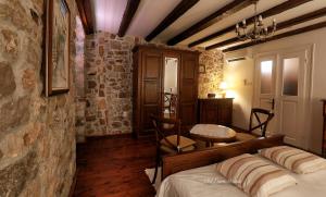 a bedroom with a bed and a table in it at Old town house in Pag
