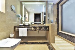 
a bathroom with a sink, toilet and a mirror at Tolip Resort El Galala Majestic in Ain Sokhna

