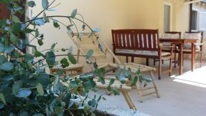 a living room with a staircase and chairs and a plant at Eco Apartments Kate in Suđurađ