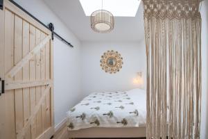 a bedroom with a bed and a wooden door at Sea Cottage Zandvoort in Zandvoort