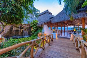 a wooden walkway to a resort on the beach at Las Hadas by Brisas in Manzanillo