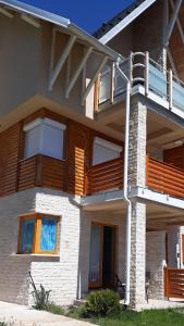 a building with wooden balconies on the side of it at Zlatiborska ćurka in Zlatibor