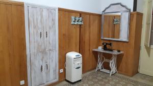 a bathroom with wooden walls and a sink and a mirror at Casa rural el Burro para grupos in Agüimes