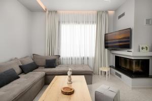 a living room with a couch and a table at Diamond Dream III in Kalamaki Heraklion