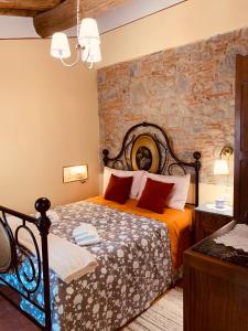 a bedroom with a bed and a stone wall at Casa Emma Fiattone in Garfagnana in Fiattone +47 photos