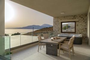 a dining room with a table and a view of the water at Diamond Dream III in Kalamaki Heraklion