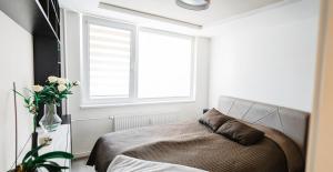 A bed or beds in a room at AH Považská