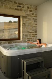 a woman in a hot tub in a room at Diamond Dream III in Kalamaki Heraklion +37 photos