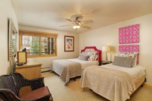 a bedroom with two beds and a ceiling fan at Shadowbrook 202-203 in Snowmass Village