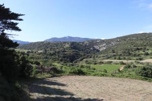 a dirt road leading into a valley with mountains at Gite Aigues Vives in Montpeyroux