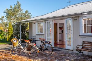 two bikes parked in front of a house at The Wine Shed in Martinborough 