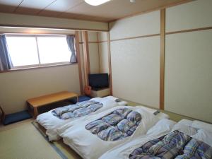 Cama o camas de una habitación en Maruni Ryokan