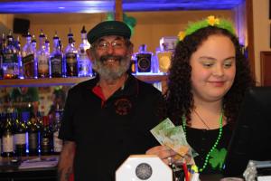 a man and a woman standing behind a bar at Blackball's Inn & 08 Cafe in Blackball