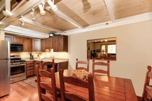 a kitchen with a wooden table and a dining room at Aspenwood 2 bedroom K-17 in Snowmass Village